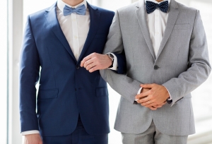 Same sex couple holding hands.